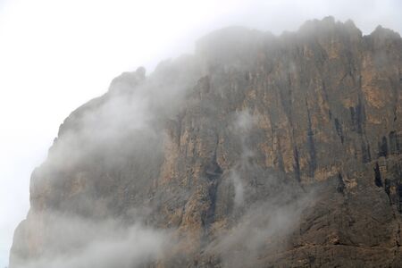 The top of the Dolomites in Italy in the fog. Autumn foggy morning. Selective focusの写真素材