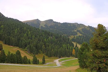 Picturesque landscape of foggy morning in mountain village in Dolomites Alps, selective focusの写真素材