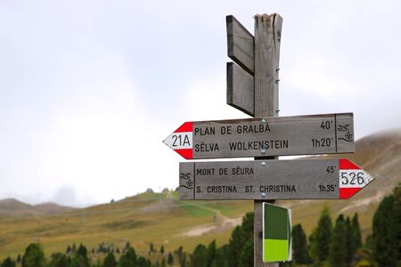 Mountain distance sign. Hiking trail in Italian Dolomites, Pian dei Menis with a view on majestic...