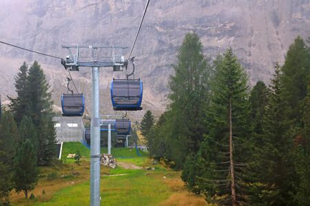 The cableway cabin does not work for climbing to the top of the mountain with a resting place, restaurant and hotel on a foggy day. Quarantine. Dolomites, Italy. Selective focusの写真素材