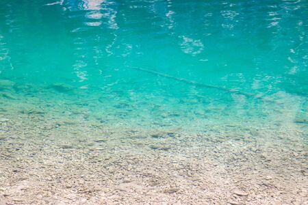 Beautiful clear cold clear water in a lake or river in the mountainsの写真素材