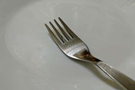 View of a white plate with a fork for food
