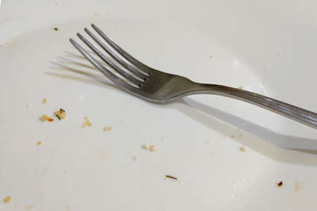 Fork on empty dirty dishes after eating. Selective focusの写真素材