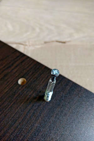 Connecting bolt or element for assembling furniture. Selective focus