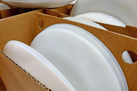 In cardboard boxes are clean white platesの写真素材