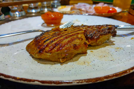 A piece of chicken steak on a plateの写真素材