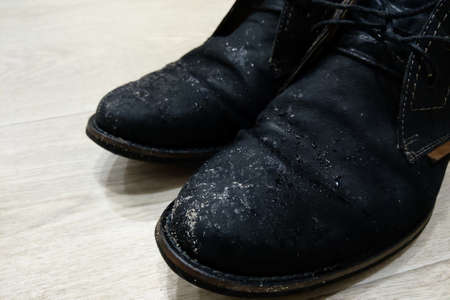 Wet dirty shoes after the street. The onset of autumn and cold weatherの写真素材