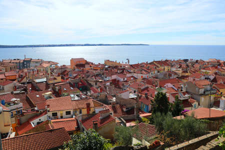 Top view on houses with red tiles and sea in the city of Piran, Sloveniaの写真素材