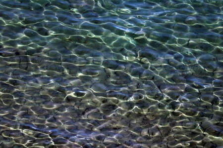Beautiful clear water with a dark bottom. Background, textureの写真素材