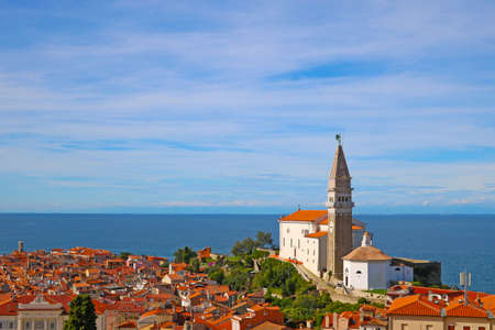 Top view on houses with red tiles and sea in the city of Piran, Sloveniaの写真素材