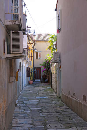Narrow dark street in the city of Koper, Sloveniaの写真素材
