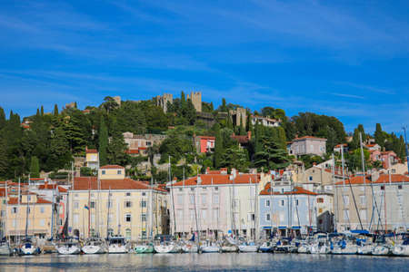 View from the water to the pier and the top of the city of Piranの写真素材