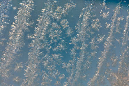 There is a frost pattern on the glass. The beginning of cold weatherの写真素材