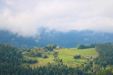 Small mountain village in a foggy morningの写真素材