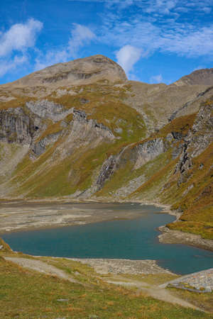 Mountain lake. Tourist route and a green valley between the mountains in Austrian Alpsの写真素材