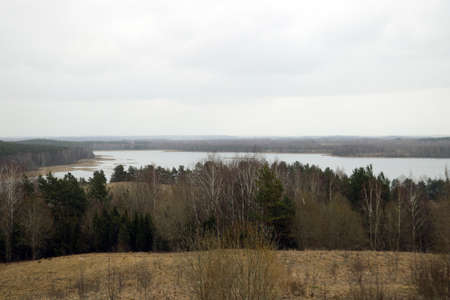 View of the large lakes and forest on a cloudy autumn morningの写真素材