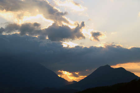 Beautiful sunset over high mountains in the autumn eveningの写真素材