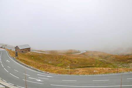 Top view of a winding mountain road in fogの写真素材