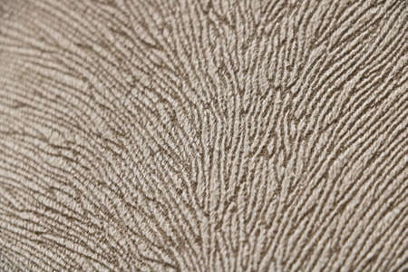 Beige fabric texture for a background in the form of curved lines