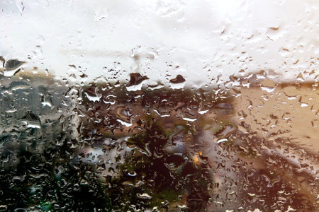 Raindrops on glass on a rainy day. Selective focus, backgroundの写真素材