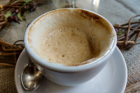 White cup with drunk hot aromatic coffee on the tableの写真素材