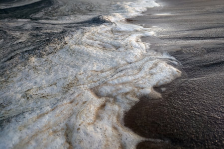 View of the foam on the seashore or ocean from the breaking wavesの写真素材