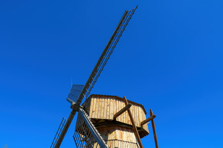 Blades of an old wooden mill on a background of blue skyの写真素材