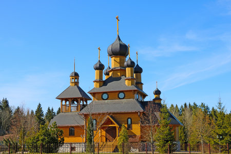 A small wooden church in the village against the background of the forestの写真素材