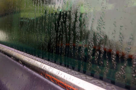 Rain drops on car glass close-up, backgroundの写真素材