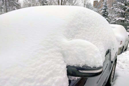 The car is covered with snow. Snowfalls in Europe and Americaの写真素材