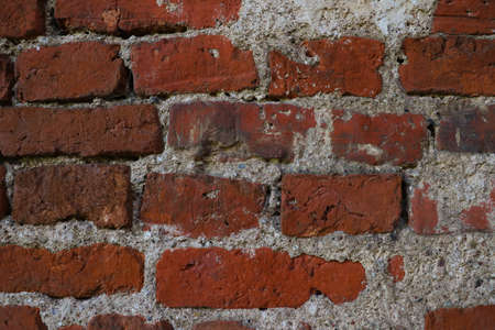 Wall of an old building made of red brick, backgroundの写真素材