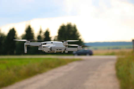 Photo of a drone flying over the roadの写真素材