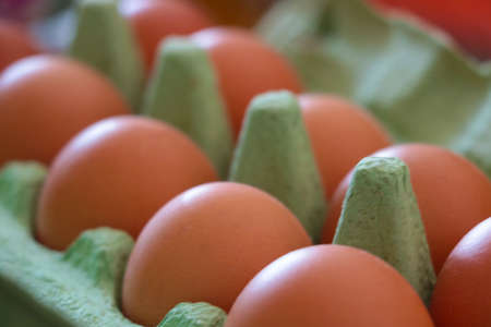 There are yellow eggs in the cardboard boxの写真素材