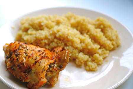 On a plate, a piece of cooked chicken and porridge. Healthy wholesome foodの写真素材