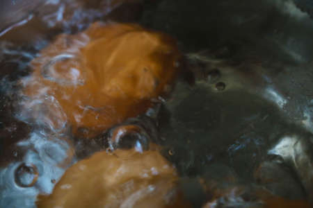 Out of focus. Blurred background. Eggs are boiled in boiling waterの写真素材