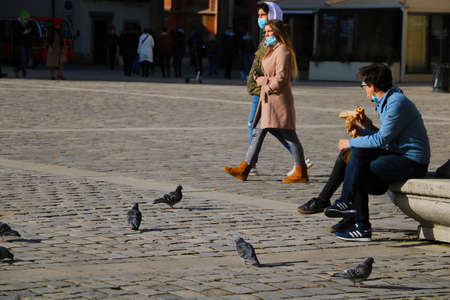 Wroclaw, Poland, March 12, 2021: People walk the streets wearing medical masks. The fight and the aftermath of the pandemicのeditorial素材