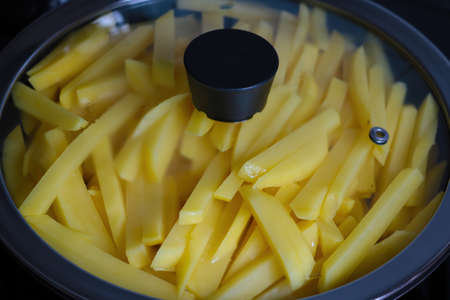 Beautiful yellow potato sliced in a frying paの写真素材