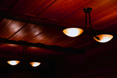 Lamps on the wooden ceiling in the roomの写真素材