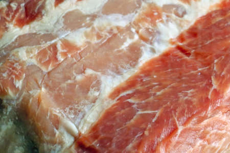 Blurry background. A close-up piece of meat lies on the tableの写真素材