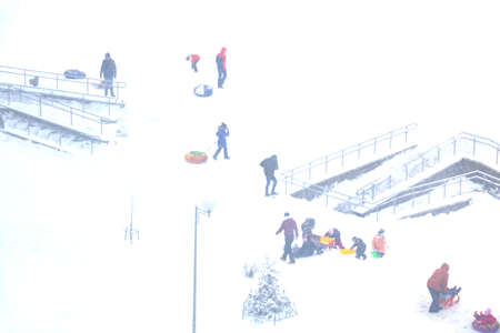 Blurry background, out of focus. View of the skiing from the slide of children in winterの写真素材
