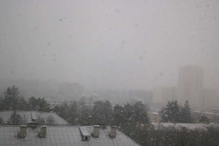 Heavy snowfall outside the window. Global climate change, environmental problemsの写真素材