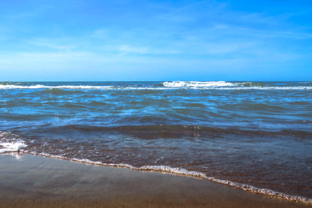 Beautiful scenic beach by the sea or ocean. Sunny clear day with blue skyの写真素材