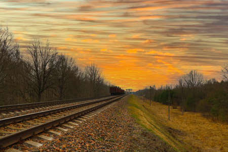 Beautiful picturesque sunset against the background of the railwayの写真素材