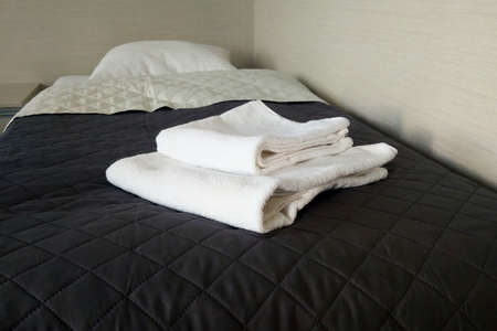On the bed are clean towels, clean room.の写真素材