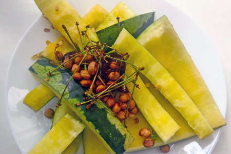 On the plate are waste from the yellow watermelonの写真素材