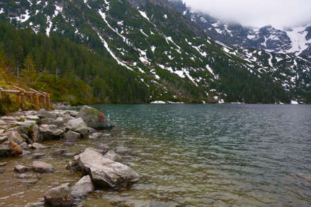 View of a mountain lake with clear turquoise waterの写真素材