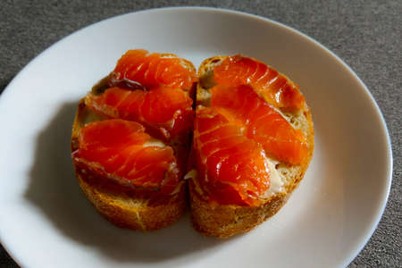 Sandwich on a white plate of red fishの写真素材