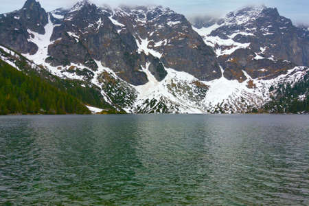 View of the lakes against the backdrop of mountains with snowの写真素材