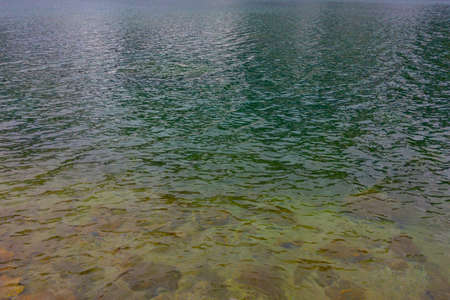 Beautiful turquoise water in a mountain lake. Background, texture of water.の写真素材