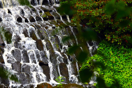 Water falls down a wall of stonesの写真素材